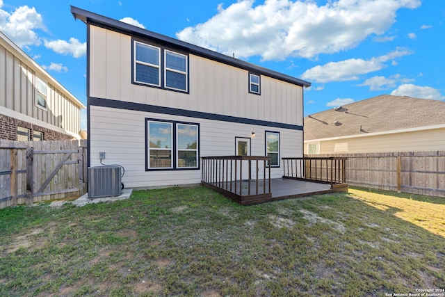 back of house with a wooden deck, a lawn, and central air condition unit