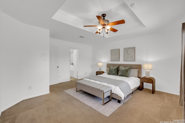 bedroom featuring light carpet, a raised ceiling, and ceiling fan