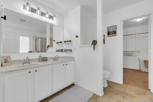 bathroom with vanity, toilet, and an enclosed shower