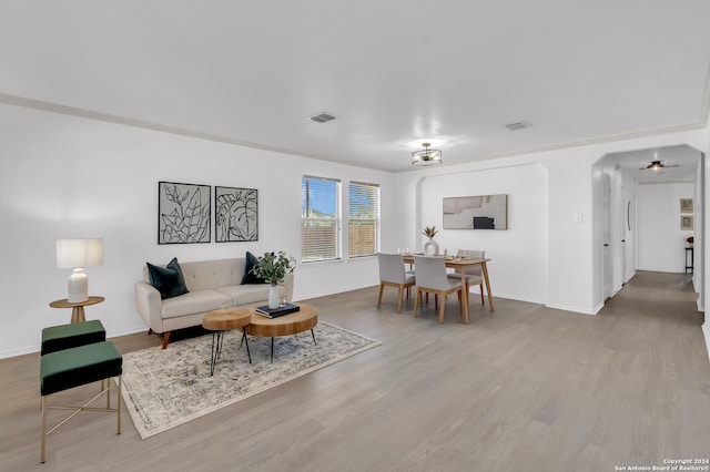 living room with hardwood / wood-style floors and ornamental molding