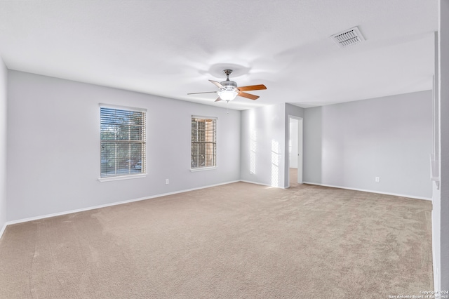 spare room with light carpet and ceiling fan