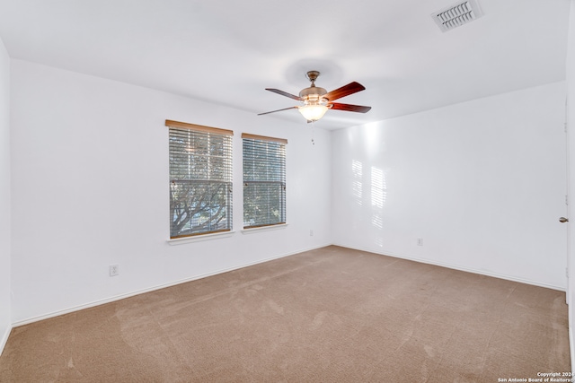 empty room featuring carpet flooring and ceiling fan