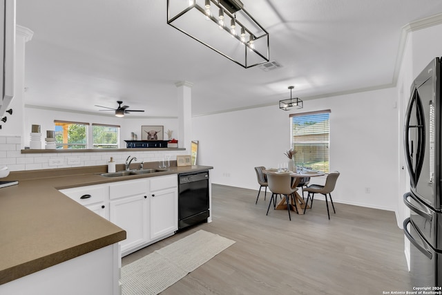 kitchen featuring dishwasher, sink, stainless steel fridge, tasteful backsplash, and white cabinetry