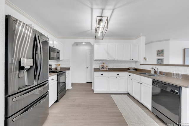 kitchen with white cabinetry, sink, tasteful backsplash, light hardwood / wood-style floors, and black appliances