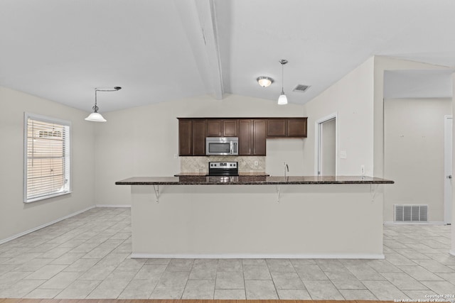 kitchen with appliances with stainless steel finishes, dark stone counters, a breakfast bar, dark brown cabinets, and pendant lighting