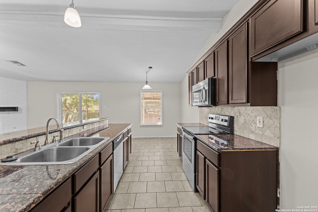 kitchen featuring pendant lighting, dark brown cabinetry, stainless steel appliances, and sink