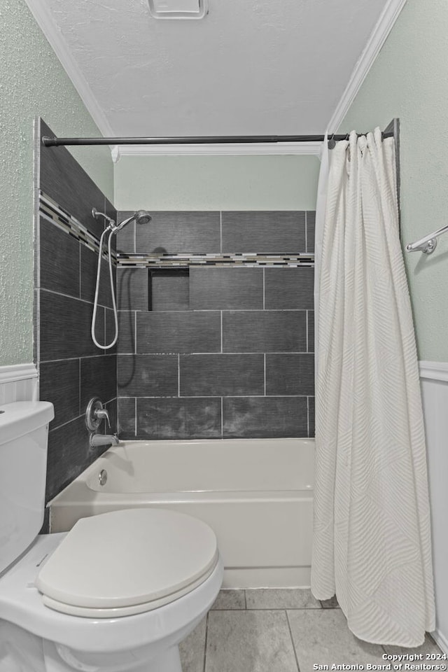 bathroom featuring tile patterned flooring, shower / bath combo, toilet, and crown molding