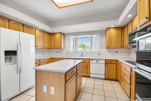 kitchen featuring a center island, sink, stainless steel appliances, backsplash, and light tile patterned floors