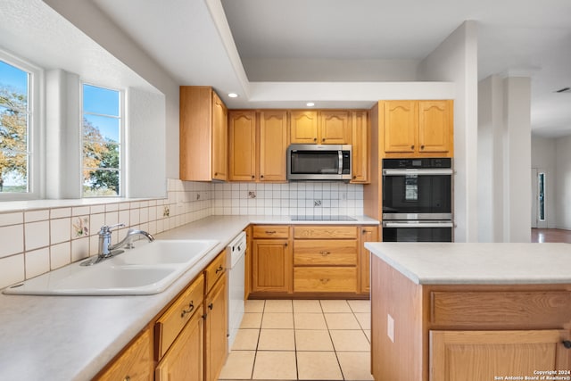 kitchen featuring decorative backsplash, light tile patterned floors, sink, and appliances with stainless steel finishes