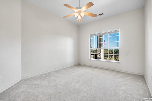 carpeted spare room with ceiling fan