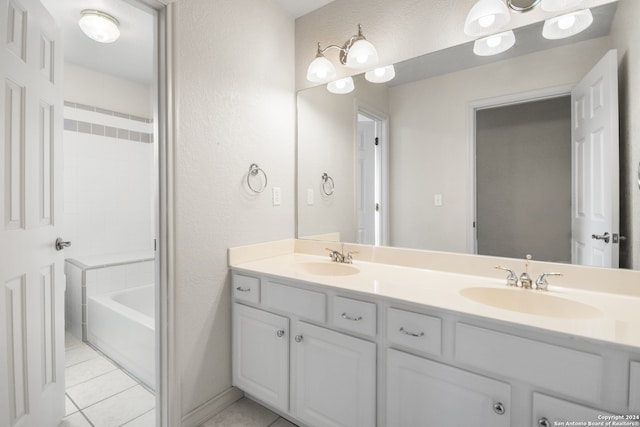 bathroom with tile patterned floors, vanity, and a washtub