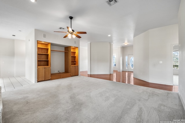 unfurnished living room featuring ceiling fan and light hardwood / wood-style floors