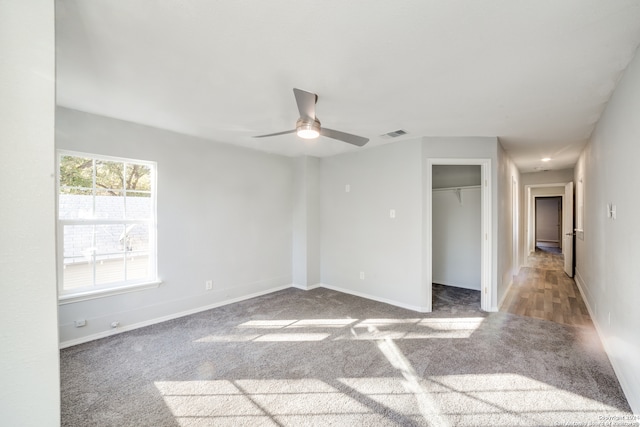 unfurnished room with ceiling fan and light colored carpet