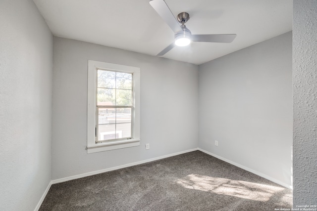 carpeted spare room with ceiling fan