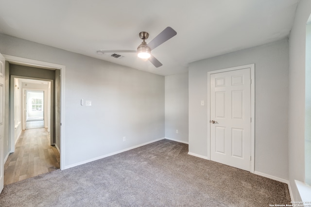 carpeted empty room with ceiling fan