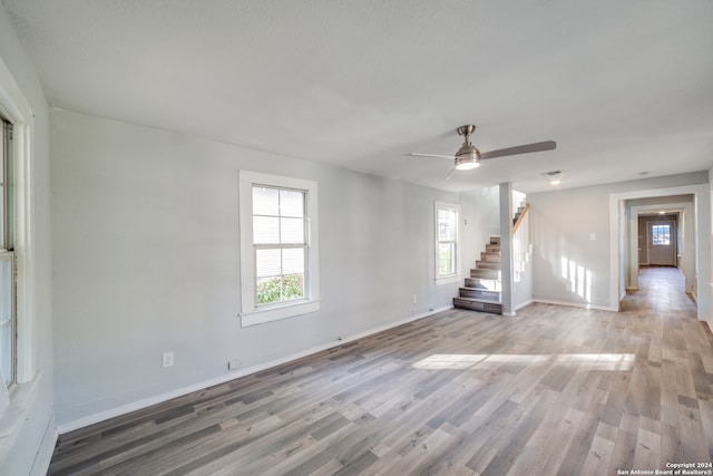 empty room with hardwood / wood-style floors and ceiling fan