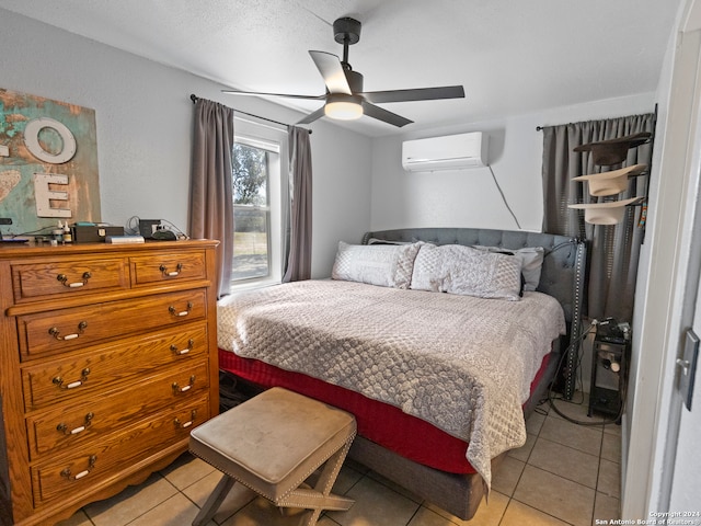 bedroom featuring light tile patterned flooring, a wall mounted AC, and ceiling fan