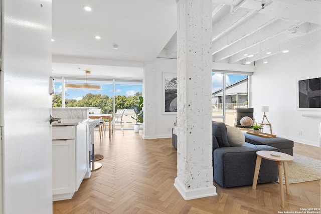 sitting room featuring recessed lighting, a wealth of natural light, and baseboards