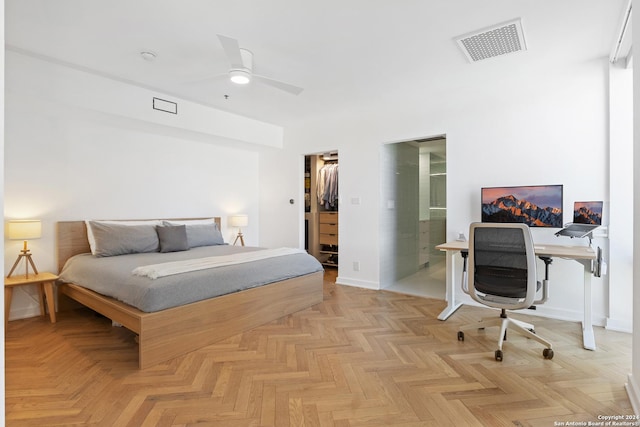 bedroom with connected bathroom, visible vents, baseboards, a closet, and a walk in closet