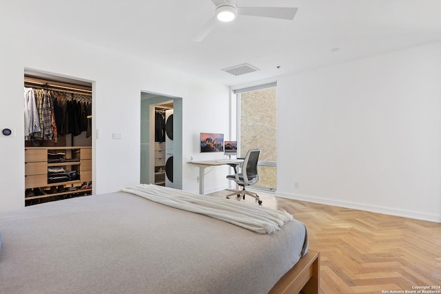 bedroom featuring visible vents, baseboards, a ceiling fan, a spacious closet, and a closet