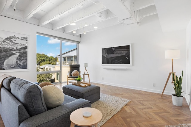 living room with beamed ceiling and baseboards