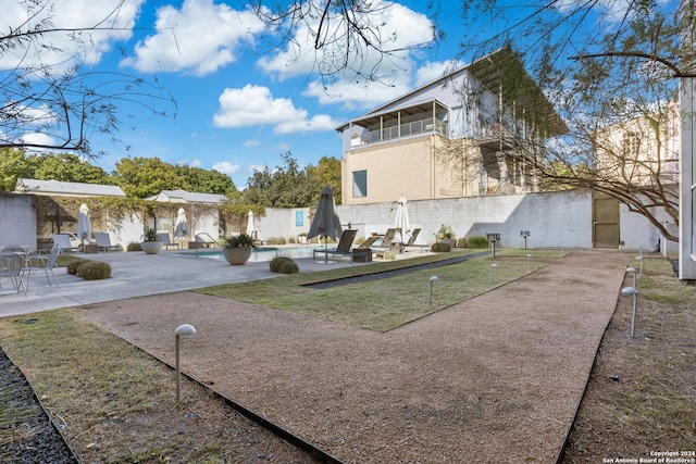 view of yard with fence, a fenced in pool, and a patio