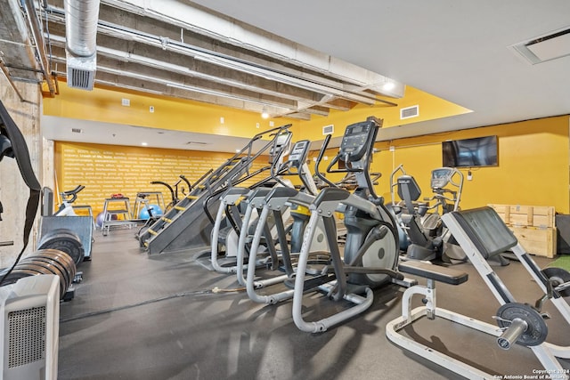 gym with brick wall and visible vents