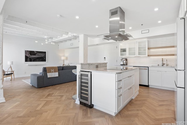 kitchen featuring wine cooler, island range hood, white cabinets, dishwasher, and glass insert cabinets