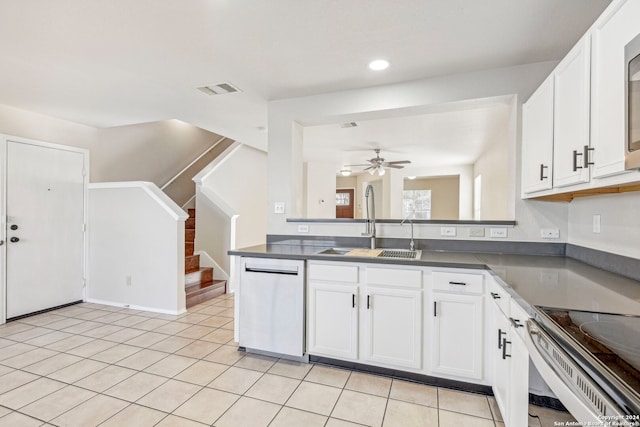 kitchen with stainless steel appliances, white cabinetry, ceiling fan, and sink