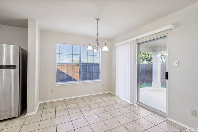 unfurnished dining area featuring light tile patterned floors and a notable chandelier