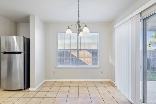 unfurnished dining area with light tile patterned floors and a chandelier