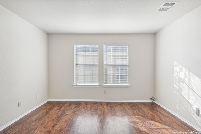 spare room featuring dark hardwood / wood-style flooring