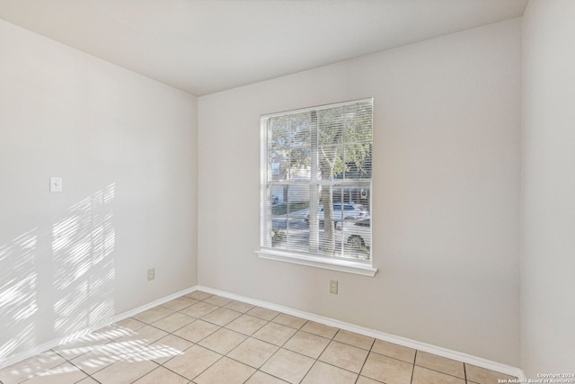 tiled spare room featuring plenty of natural light