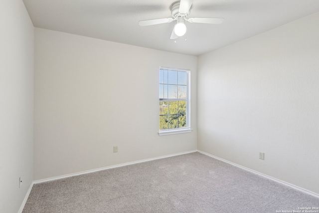 empty room with ceiling fan and light colored carpet