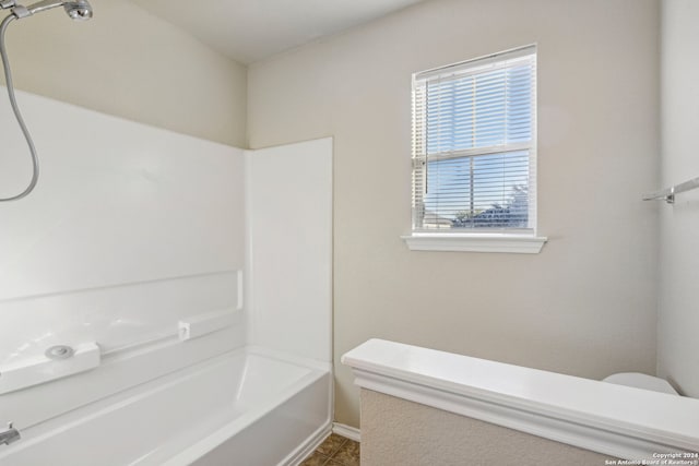 bathroom featuring tile patterned flooring,  shower combination, and toilet