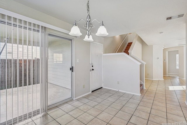 unfurnished dining area featuring light tile patterned floors and a chandelier