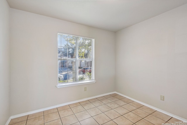 spare room with light tile patterned floors and a healthy amount of sunlight