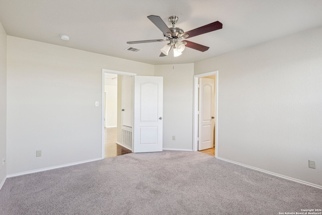 unfurnished bedroom featuring ceiling fan and light carpet