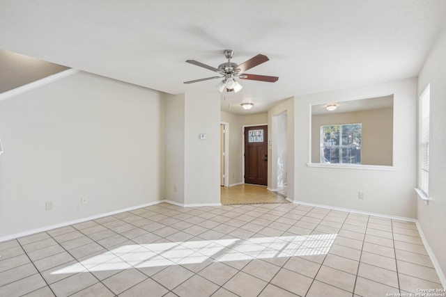 spare room featuring ceiling fan and light tile patterned floors