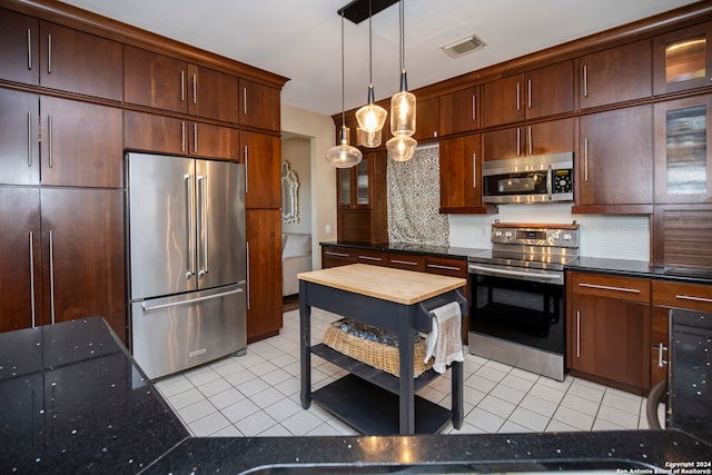 kitchen with pendant lighting, light tile patterned floors, stainless steel appliances, and dark brown cabinets