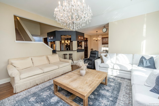 living room with hardwood / wood-style flooring and a notable chandelier