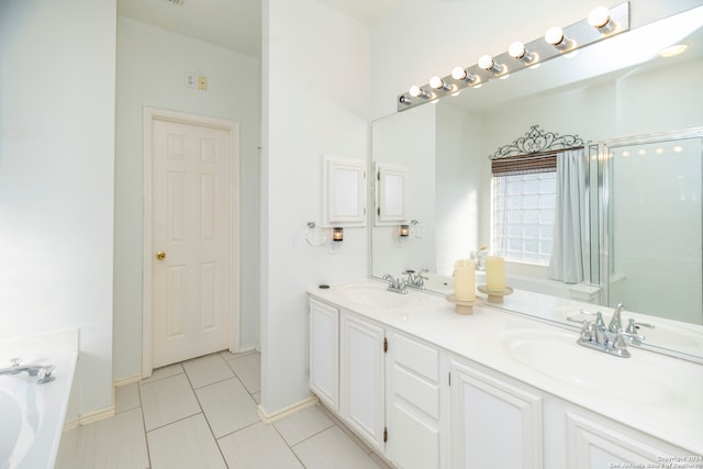 bathroom featuring plus walk in shower, vanity, and tile patterned floors