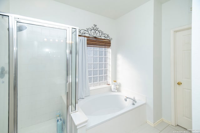 bathroom featuring tile patterned flooring and separate shower and tub