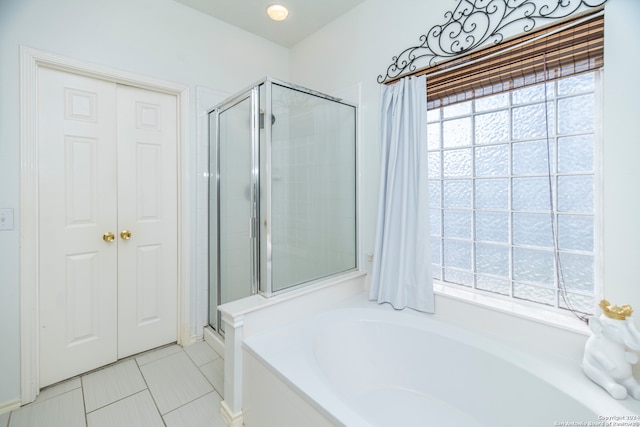 bathroom with tile patterned floors and plus walk in shower