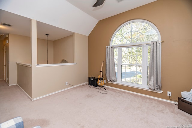 spare room featuring carpet floors, ceiling fan, and lofted ceiling