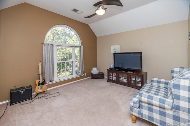 carpeted living room with ceiling fan and lofted ceiling