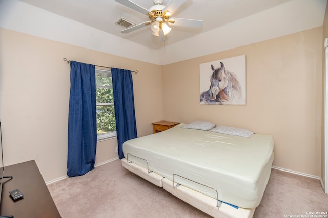 bedroom with ceiling fan and light carpet