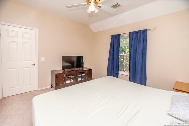 carpeted bedroom featuring ceiling fan and vaulted ceiling