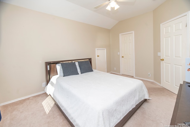 carpeted bedroom with ceiling fan and lofted ceiling