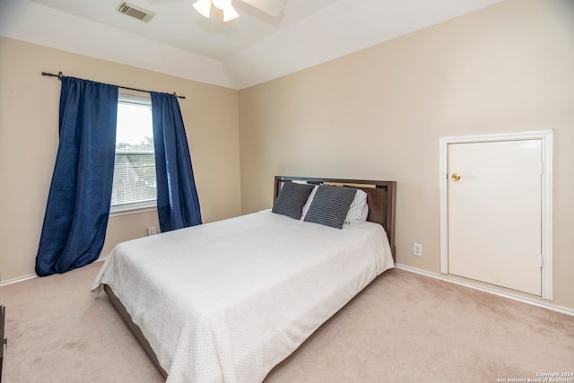 carpeted bedroom with ceiling fan and lofted ceiling